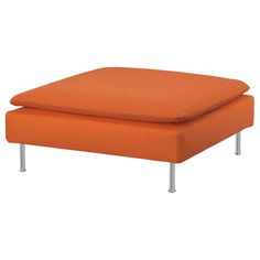 an orange ottoman sitting on top of a metal frame