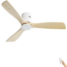 a person holding a remote control in front of a ceiling fan that is turned on