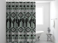 a black and white shower curtain in a bathroom with cactus designs on the shower curtain