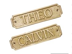 two metal tags with the words,'theo and cavin'on them