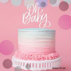 a pink and white cake with the word oh baby on top