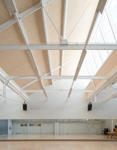 an empty gym with hard wood floors and white walls