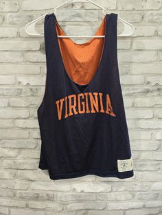 University of Virginia College Sleeveless Shirt Blue Reversible Mesh Jersey Size Large Measures 22" Length x 46" Chest Collegiate Blue Sleeveless Tops, Blue Sleeveless Collegiate Tops, Blue Sleeveless Collegiate Style Top, Blue Sleeveless Vest For Streetwear, Collegiate Sleeveless Top For Streetwear, Collegiate Sleeveless Tank Top For Sports, Sleeveless Blue Tops For College, Collegiate Sleeveless Cotton Top, Navy Stretch Tank Top