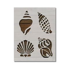 four seashells are cut out from wood