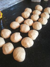 doughnuts are lined up on the counter ready to be baked in the oven