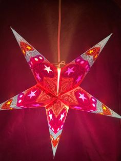 an origami star hanging from a string