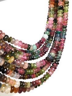 multicolored glass beads are arranged on a white surface