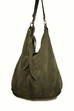 Handmade suede hobo bag make with olive green suede. This bag is unlined, inside there is a big cotton zipped pocket. The strap is make with stronger hand dyed leather and is adjustable between 21,65 inch and 43,30 inch. The has an amovable handle. The handle length is 15,64 inch. The bag is closed with a zip. This confortable hobo bag is very practical for any occasion. This bag is very large and soft and may contain many things. This bag is a sinlge piece Features : - Olive green suede, - hand Suede Hobo Bag With Zipper For Everyday Use, Everyday Suede Hobo Bag With Zipper Closure, Green Leather-handled Hobo Satchel Bag, Suede Hobo Shoulder Bag With Zipper, Suede Hobo Shoulder Bag With Zipper Closure, Suede Hobo Bag For Daily Use, Suede Hobo Bag With Zipper For Daily Use, Suede Hobo Bag With Zipper Closure For Daily Use, Travel Suede Hobo Bag With Soft Leather