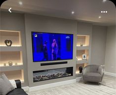 a large flat screen tv mounted to the side of a wall in a living room