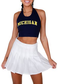 Give your tailgating look a cute update with this Michigan Wolverines Womens Tank Top! Look good and stay cool in this Navy Blue Britney Halter Sleeveless Shirt. This Michigan Tank Top features a center chest screen print team name. Halter straps, Open back with double ties, Soft hand, Finished seams, Sleeveless, 95% Cotton/ 5% Spandex, 4 Collegiate Summer Tops For Cheerleading, Blue Fitted Tops For College, Blue Spring Tops With School Spirit Style, Blue Tops For Spring School Spirit, Blue Spring Tops For School Spirit, Collegiate Style Fitted Tops For Spring, Fitted Tops For Cheerleading In Spring, Fitted Preppy Summer Top, Navy Preppy Top For Summer