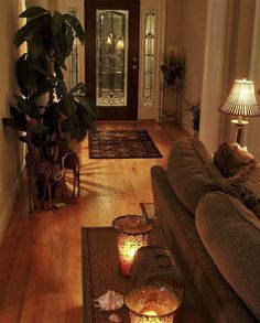 a living room filled with lots of furniture and decor on top of a hard wood floor