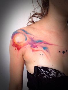 a woman's chest with colorful ink on it