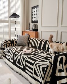 a living room with zebra print furniture and white walls