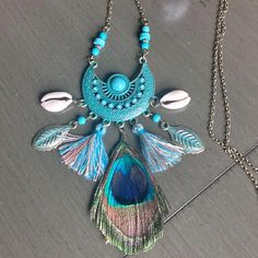 This Pendant Necklace Has A Lot Of Beauty And Is The Epitome Of Bohemian Charm. Burnished Gold Metal Is Given A "Vintage" Look With A Turquoise Patina And It's Embellished With "Turquoise" Accents. From This Main Part Of The Pendant Two Cowrie Shells, Two Tassels, Two Turquoise Patina Leaf Charms And A Peacock Feather Dangle. Necklace Measures Approx. 31.5" With A 16" Drop. Turquoise-Colored Beads Adorn The Chain Right Above The Start Of The Pendant. * The Pendant Measures Approx. 3 1/2" Long X Handmade Turquoise Tassel Necklace In Bohemian Style, Blue Bohemian Necklaces For Vacation, Turquoise Bohemian Necklace For Vacation, Bohemian Blue Jewelry For Festivals, Bohemian Blue Jewelry For Summer, Bohemian Fringe Jewelry For Beach, Bohemian Beach Jewelry With Tassels, Hippie Blue Necklaces For Festivals, Bohemian Beach Jewelry With Fringe