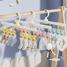 there is a rack with baby's socks hanging from it and a doll next to it