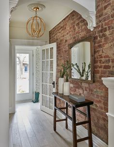 a hallway with brick walls and wooden floors