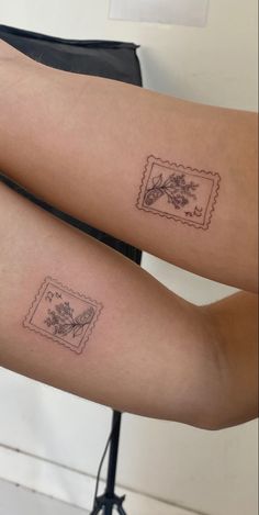 two people with tattoos on their legs, one has a stamp and the other has a flower