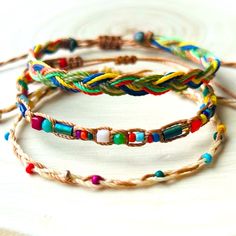 three different colored bracelets on top of each other