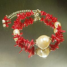 Pearl is a symbol of purity, integrity, wisdom and resilience.  It is one of the most potent symbol of creating something beautiful out of a painful experience. Coral- a stone that is called the "garden of the sea."  It is said to prevent ill fortune and to aid in soothing, intuition, imagination and energizing the emotion. This's gorgeous large pearl coral bracelet.  There is natural freshwater pearl in shimmery creamy color in focal of bracelet.  The showcase consisted with natural coral chips Single Strand Bracelet Jewelry Gift, Single Strand Bracelet As Gift, Spiritual Single Strand Bracelet, Spiritual Single Strand Beaded Bracelets As Gift, Spiritual Single Strand Beaded Bracelet As Gift, Spiritual Single Strand Bracelet Gift, Spiritual Single Strand Bracelet As Gift, Red Spiritual Bracelets For Wedding, Spiritual Single Strand Bracelet For Gift