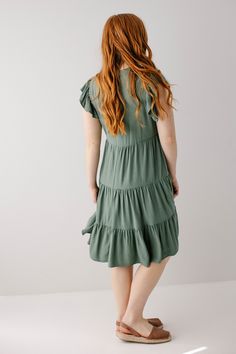 Introducing the 'Paloma' midi dress! This midi dress is in a stunning jade color and features a beautiful tiered silhouette. Carrying both comfort and feminine grace, this dress is a great addition to your warm weather closet! Pair with brown sandals and a tote bag for a casual day out or a brunch with friends. 70% Rayon 30% Linen Wash Inside Out Wash Cold Gentle Cycle Do Not Bleach Hang to Dry Low Iron if Needed Do Not Dry Clean Partially Lined Great petite length option! Model Height 5'6" | We Solid Color Tiered Skirt Midi Dress For Spring, Spring Solid Color Tiered Dress With Ruffle Hem, Spring Solid Color Tiered Skirt Dress, Tiered Dress With Ruffles, Solid Color Tiered Skirt Dress With Ruffles, Spring Solid Color Tiered Dresses, Tiered Skirt Dress For Brunch, Solid Color Tiered Dress For Brunch, Tiered Dress For Brunch