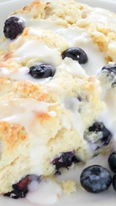 blueberry scones with icing on a white plate