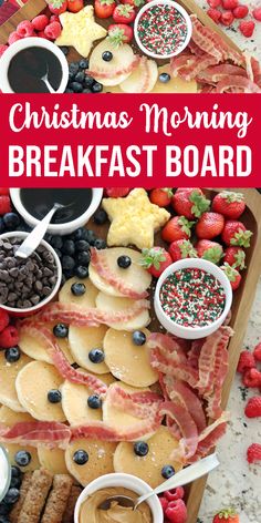 christmas morning breakfast board with bacon, pancakes, berries and other foods on it in the middle