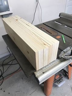 a piece of wood sitting on top of a table next to a sawing board