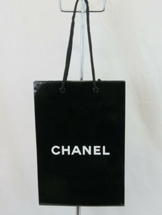 CHANEL BLACK GLOSS PAPER SHOPPING GIFT BAG FOR CLOTHES GIFTS ACCESSORIES  100% AUTHENTIC Color: BLACK White "CHANEL" logo on both side of a bag Size: VARIOUS NOTE: The colors of the products and the colors of the inscriptions on them  on the monitor screen may differ from the actual colors of the products and the colors of the inscriptions of them. NOTE!!!!! International Buyers: Import duties, taxes and charges are NOT included in the item price or shipping cost. These charges are the buyer's r Trendy Black Bags With Logo Print, Bag For Clothes, Chanel Logo, Black Gloss, Coach Horse And Carriage Tote, Chanel Black, Party Card, Gift Accessories, Clothes Gift