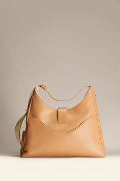 Introducing the Reverie Hobo—a dream come true for the urban adventurer who values conscious artistry. Made for the big dreamer, this soft and resilient bag is crafted from recycled leather scraps, offering a touch as gentle as a cloud. Its graceful silhouette houses multiple interior and exterior pockets, along with a laptop compartment fitting up to a 13" laptop. The fully adjustable shoulder strap adapts to your needs, converting the bag between handbag, satchel, and crossbody styles— matching the fluidity of your personal workstyle. Handbag Satchel, Leather Scraps, Laptop Tote, Recycled Leather, Leather Hobo Bag, Leather Work, Work Bag, Leather Hobo, Bag For Women