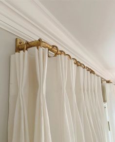 the curtain is pulled back and hanging on the wall