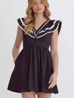 This black and white dress effortlessly combines classic elegance with modern flair. The dress features dramatic ruffled sleeves with contrasting white trim that frame the V-neckline beautifully. The smocked back ensures a comfortable fit while accentuating your waist. Ideal for both daytime outings and evening gatherings, pair this dress with strappy sandals or ankle boots for a stunning ensemble. SIZE & FIT Fit is true to size Model is 5'9" wearing size small Zipper on side Black V-neck Dress With Smocked Back, Elegant Black Dress With Contrast Trim, Elegant Black Dresses With Contrast Trim, Chic Black Dresses With Contrast Trim, Chic Black Dress With Contrast Trim, Black Dress With Contrast Trim, Black Summer Dress With Contrast Trim, Chic Lace Trim Dresses With Flutter Sleeves, Black V-neck Dress With Smocked Bodice