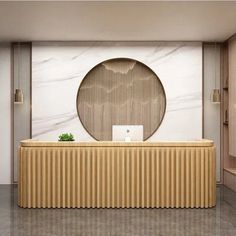 an office lobby with a marble wall and wooden countertop, along with a round mirror on the wall