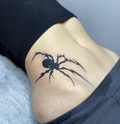 a woman with a spider tattoo on her stomach