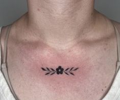 a man with a small tattoo on his chest