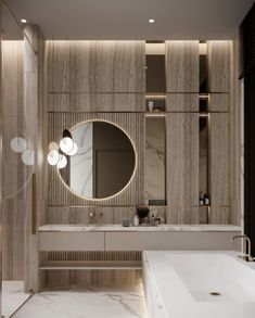 a modern bathroom with marble walls and flooring, large round mirror on the wall