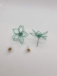 These earrings are made out of wire in the shape of a flower and then painted! There are two sizes pictured, and these are the LARGER of the two sizes. See my shop for the smaller size! @green.goddess.gift Green Flower Shape Earrings For Spring, Green Flower Earrings For Spring, Green Flower Shaped Earrings For Spring, Green Flower-shaped Earrings For Spring, Spring Green Flower Earrings With Ear Wire, Spring Green Flower Earrings, Green Flower-shaped Pierced Earrings, Green Whimsical Flower Shaped Earrings, Adjustable Wire Wrapped Flower Earrings