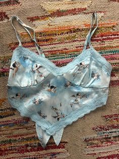 Baby Blue lace crop top with adjustable straps, ties in the back. Baby angel print   Brand: Forever 21 Size: Small Blue Lace Crop Top, Angel Print, Blue Crop Tops, Lace Crop Tops, Baby Angel, Blue Lace, Baby Blue, Casual Skirts