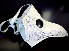 Travel back in time with our white plague doctor mask with purple filigree! Created with comfortable vegan leather, this mask is great for all-day wear and easy to breathe in. Look great and feel great with our fashionable plague masks! White/purple Color.

Age Group/Gender - Adult/Unisex
Size/Type - One size fits all adults
Mask Color - White
Filigree Color - Purple
Mask Material - Vegan Leather Plague Doctor Cosplay, Beak Mask, Plague Doctor Costume, Plague Mask, Plague Doctor Mask, Thank You Wishes, Doctor Costume, Doctor Mask, Mask White