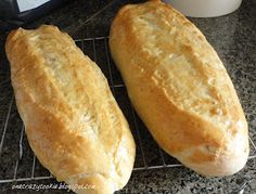 two loaves of bread cooling on a rack next to an instant pressure cooker