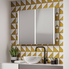 a bathroom vanity with two mirrors and a sink in front of a yellow geometric wallpaper