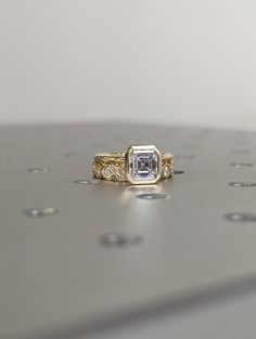 a diamond ring sitting on top of a table