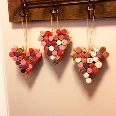 three hearts made out of wine corks hanging on a wall