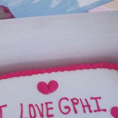 a cake with pink frosting that says, i love ghil on the side