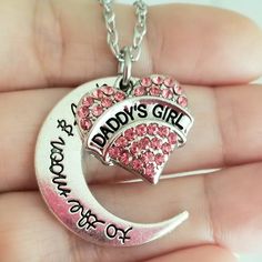 New Handmade Daddy's Girl Charm Necklace Celebrate Your Special Bond With This Beautiful Handmade Necklace. Silver Plated Pink Crystal 'Daddy's Girl' Charm With An Engraved 'To The Moon And Back' Crescent Moon Charm. 18 Inch Chain With Lobster Clasp Closure. Ships Within 24 Hours Of Purchase Monday-Saturday Daughter Gift, Daughter Christmas, Daughter Jewelry, Daughter Birthday, Father Daughter Personalized Pink Jewelry For Christmas, Cute Silver Jewelry For Birthday Gift, Cute Silver Jewelry For Gifts, Personalized Pink Jewelry For Father's Day, Cute Silver Jewelry For Mother's Day, Silver Jewelry For Personalized Cute Gifts, Silver Necklace For Birthday And Christmas, Cute Silver Jewelry For Personalized Gift, Jewelry Daughter