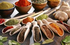 several spoons filled with different types of spices