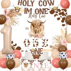 the first birthday photo frame is decorated with balloons, cake and cow head on it