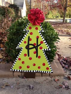 a christmas tree made out of cardboard with a red bow on it's head