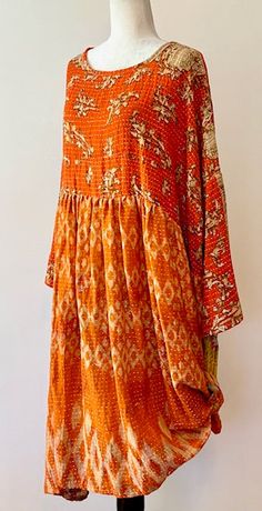 The Daydreamer midi dress is crafted from vintage cotton Kantha embroidered sari. This babydoll inspired silhouhette is both effortless and flattering. It features 3/4 sleeves that are split so you can roll or tie them up, a midi length kantha skirt, a babydoll fit, and POCKETS, of course. Deep pockets to hold all your essentials. We love this style tucked into shorts, worn over wide leg jeans, or styled as a dress on its own. A true boho prairie feel. (Psst...Many customers are removing the bra Bohemian Straight Kurta Dress For Festivals, Festive Bohemian Orange Dress, Bohemian Block Print Tunic For Festive Occasions, Bohemian Festive Maxi Dress With Chikankari Embroidery, Festive Bohemian Maxi Dress With Chikankari Embroidery, Bohemian Maxi Dress With Bandhani Print, Orange Chikankari Embroidered Dress For Festivals, Bohemian Summer Kurta For Festive Occasions, Traditional Summer Dress With 3/4 Sleeves