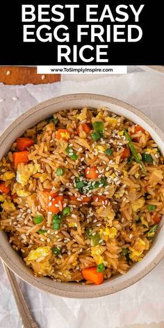 the best egg fried rice recipe in a bowl with chopsticks next to it