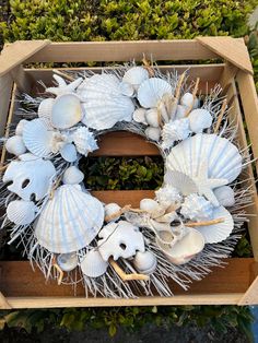 a wreath made out of seashells in a box